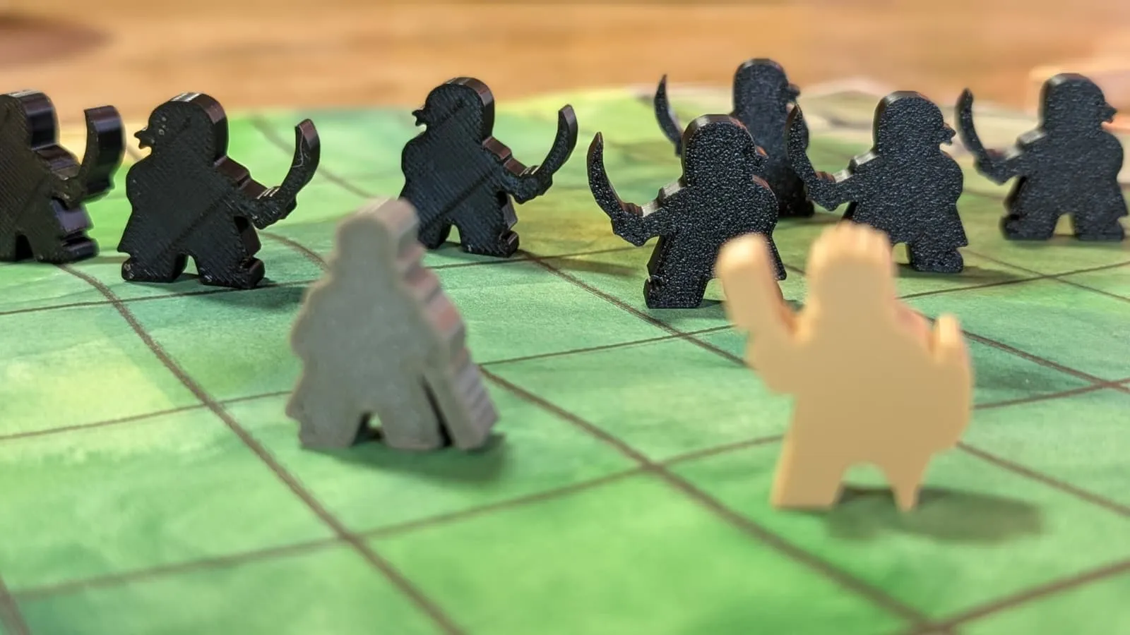 Eight dark enemy figures facing two paler courier figures, shot from table height