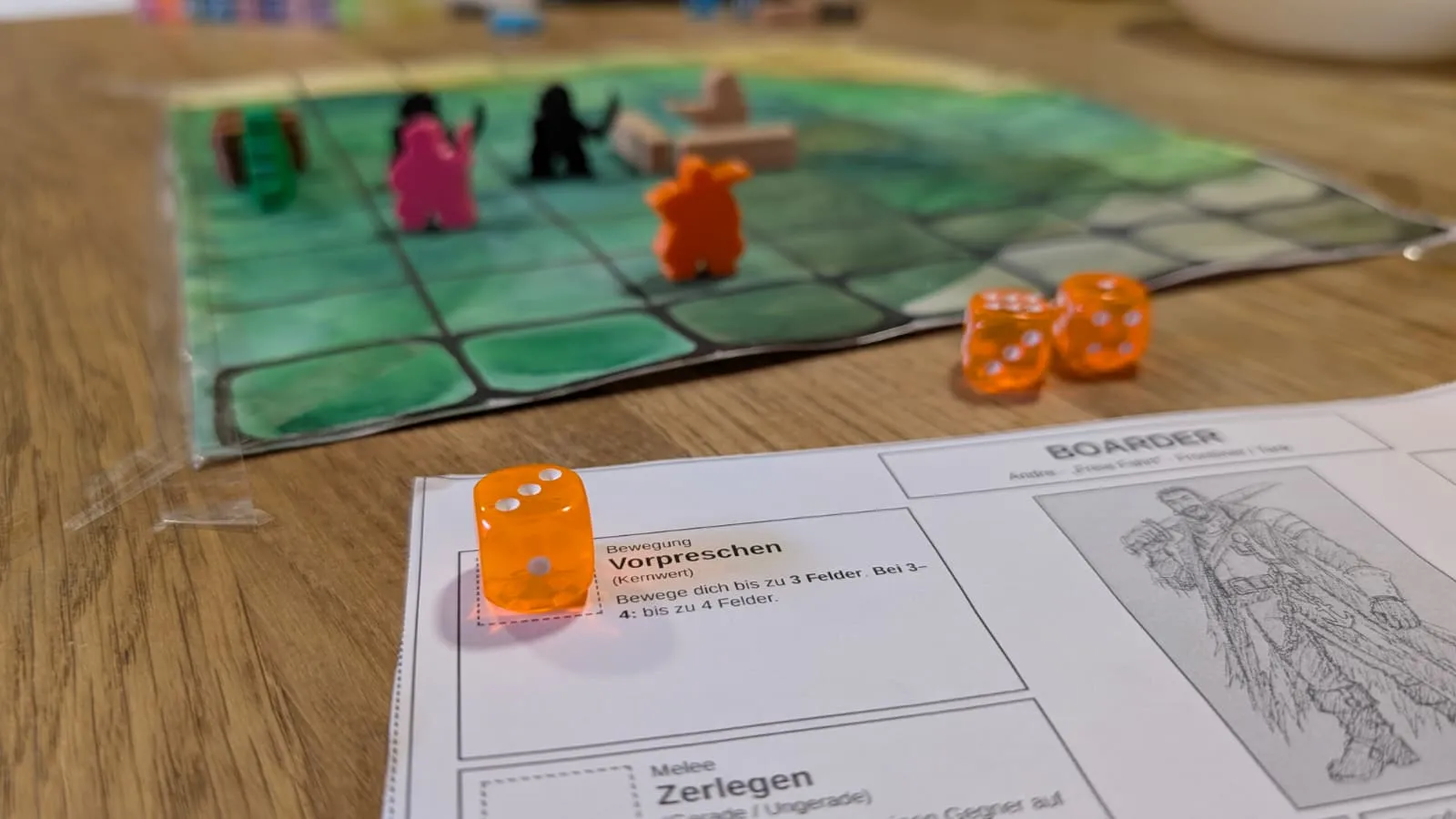 An orange die sitting on the movement slot of a character sheet, two more dice on the table beside it